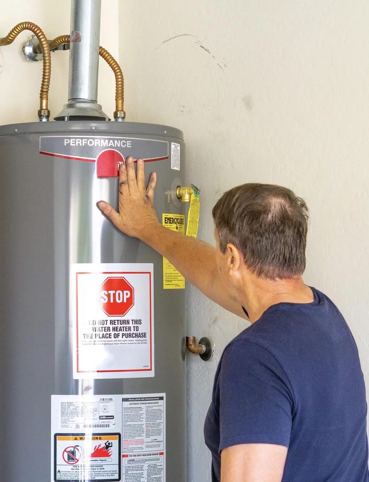 Technician installing a residential water heater